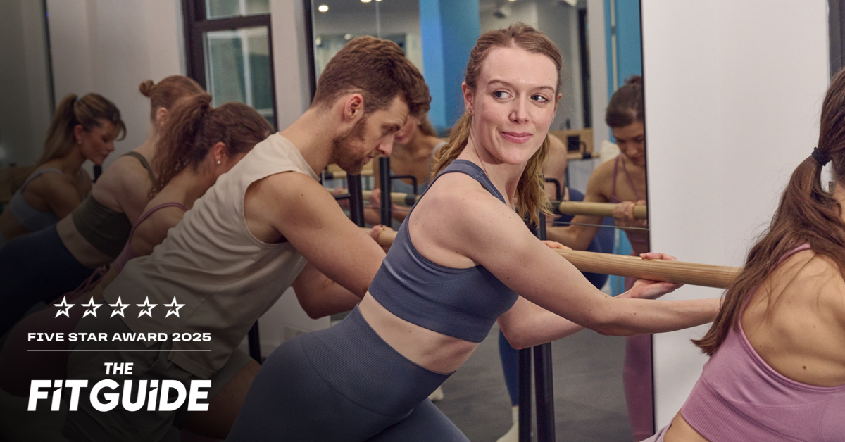An athletic woman exercising at a barre
