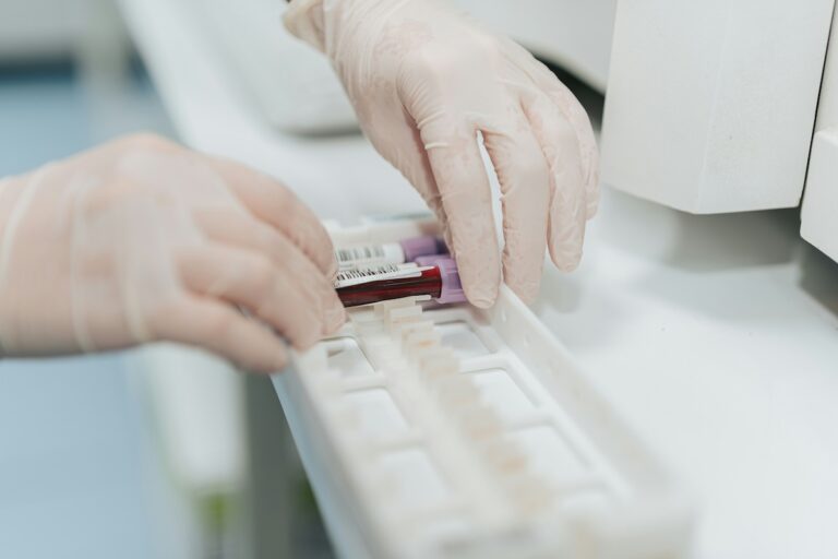 Phlebotomy technician holding a syringe