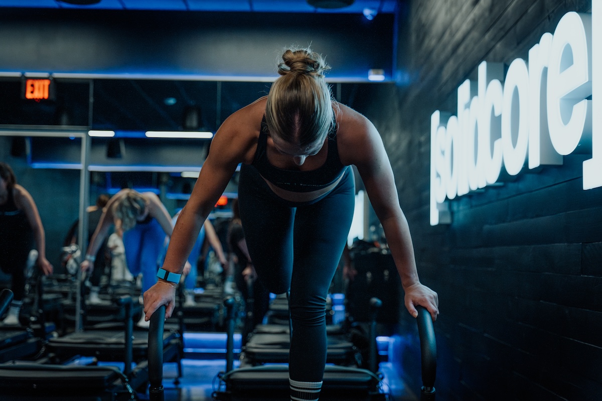 A woman performing a pilates moving using a reformer
