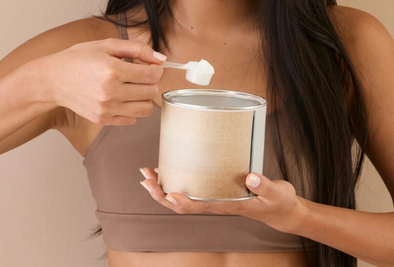 A woman scooping a powdered supplement