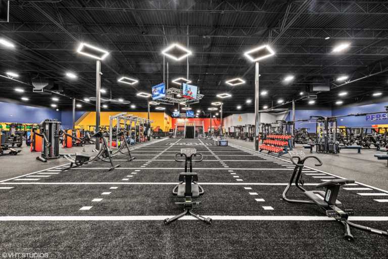 Gym floor with black turf and cardio equipment