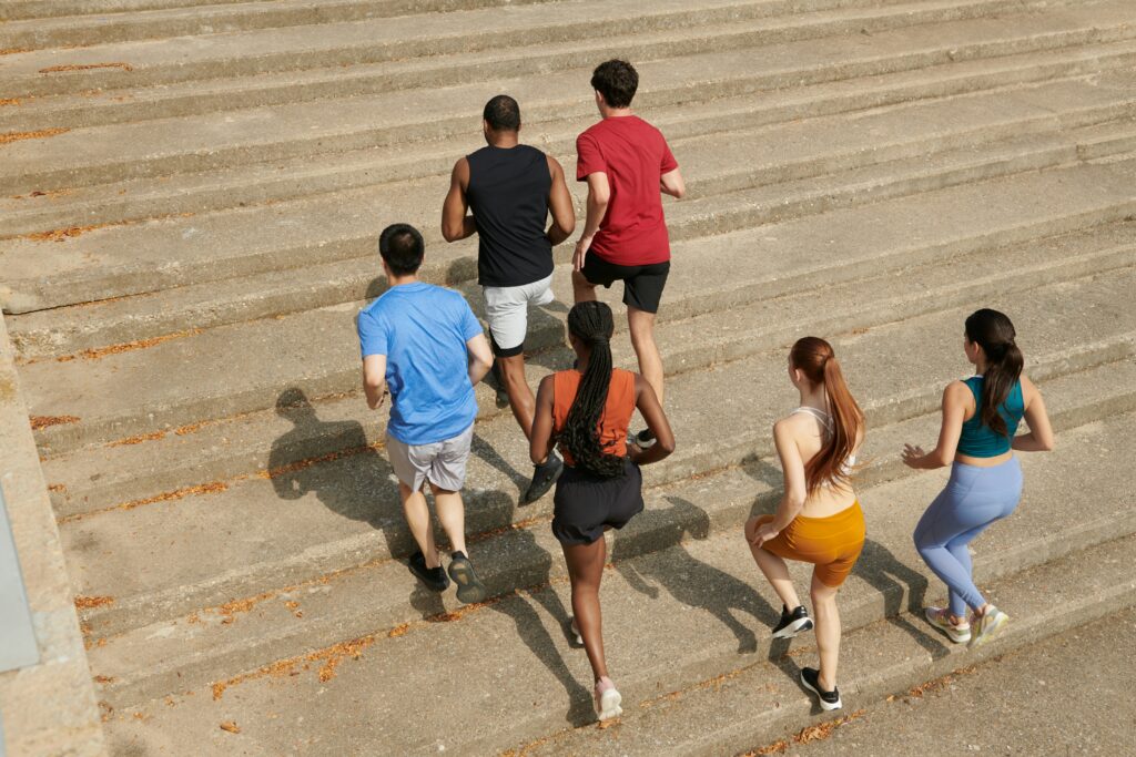 Group of people running up a staircase