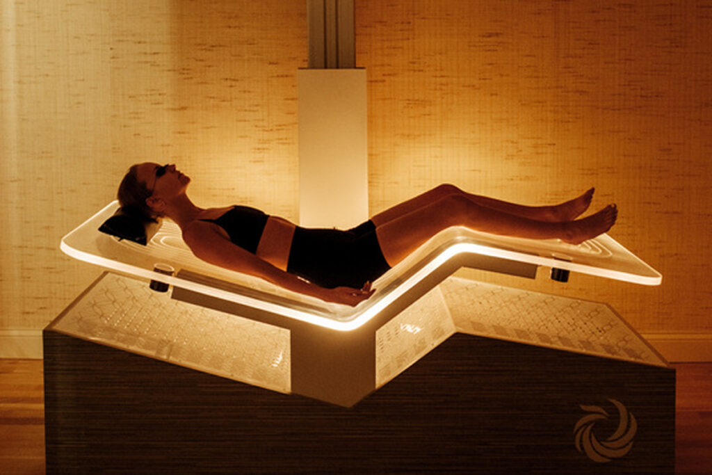 A woman lying down on a light bed