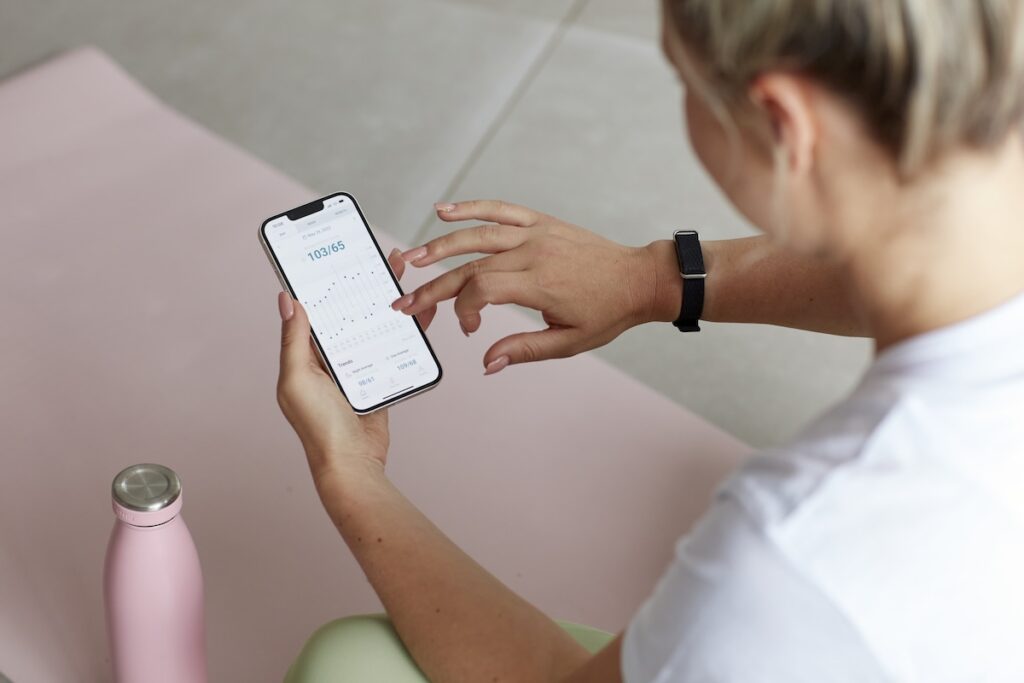 A woman checking her heart rate on her phone