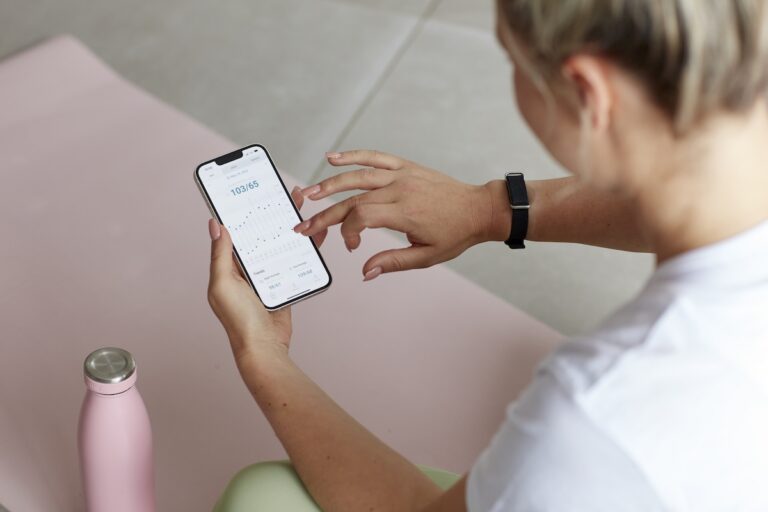 A woman checking her heart rate on her phone