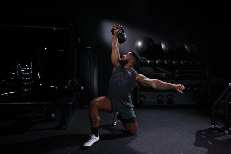 A fit man performing a kettlebell exercise