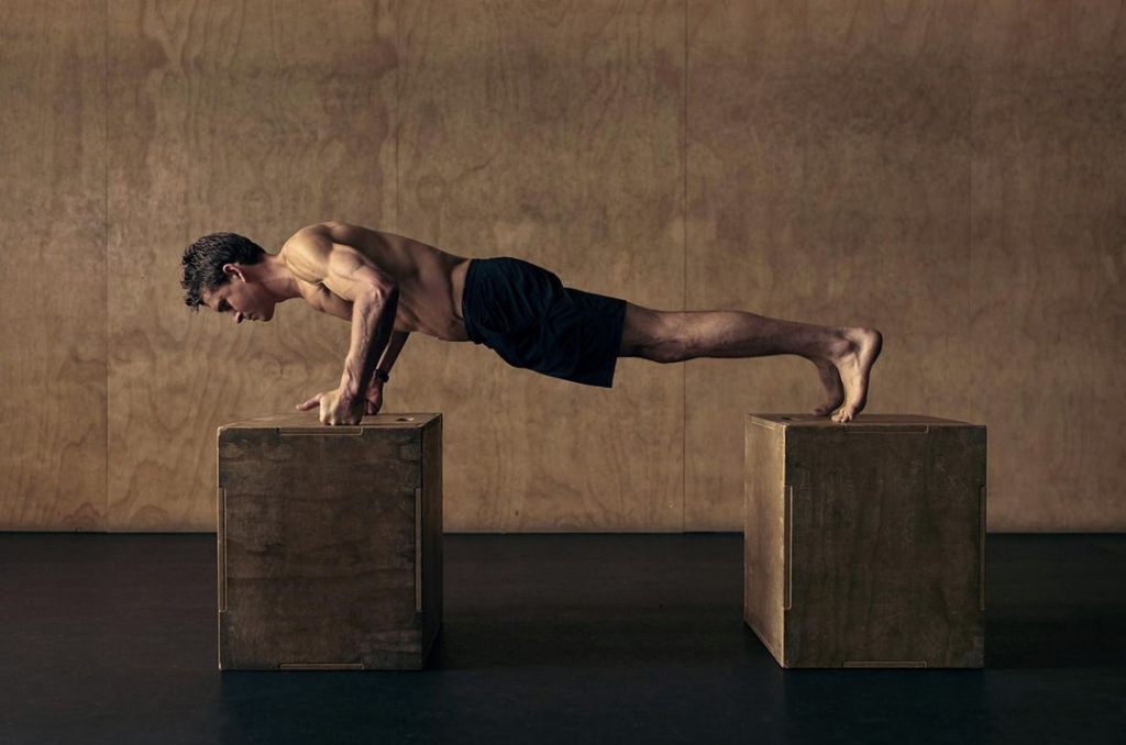 Ben Greenfield performing a plank on two boxes