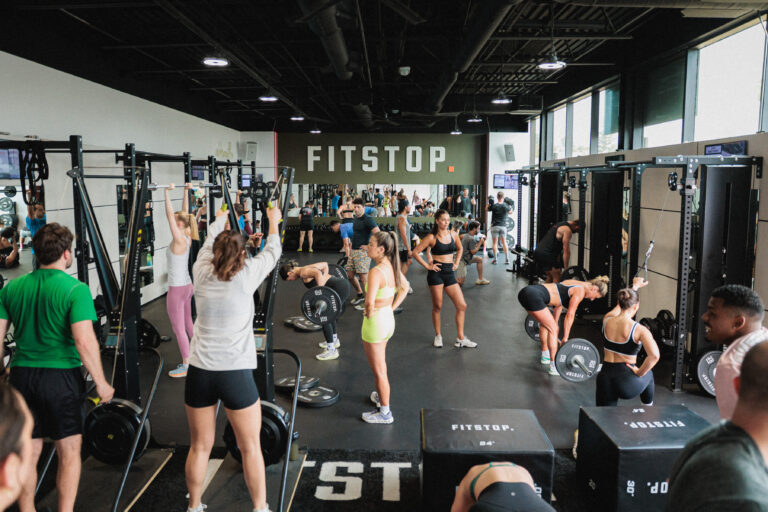 Group of exercisers in a Fitstop weight room.