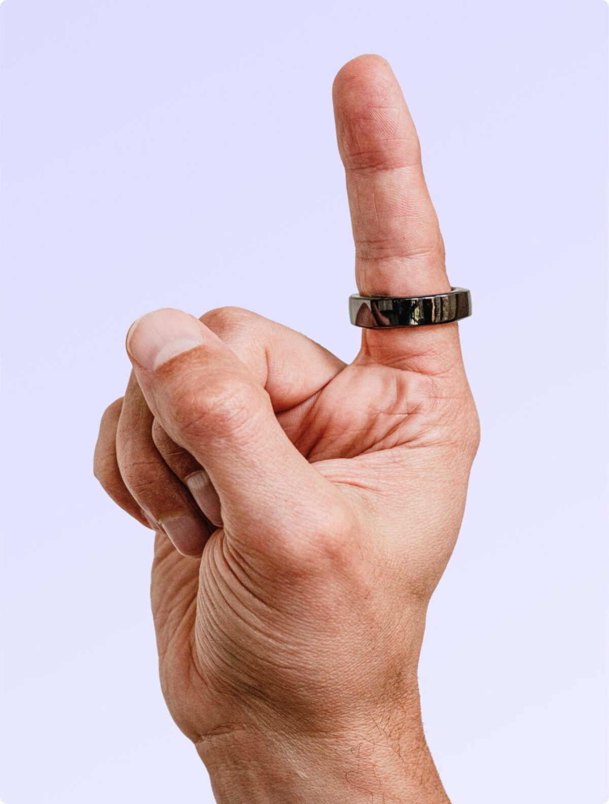 Hand with the glossy black Happy Ring on the index finger