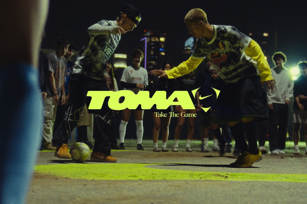 Nike Toma watermark overlayed on two people playing soccer