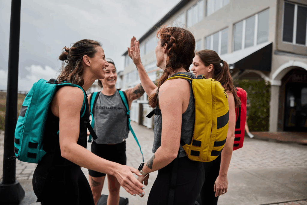 Group of women with weighted packs embracing