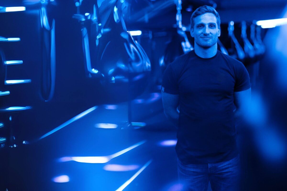 A man in a dark-lit fitness room