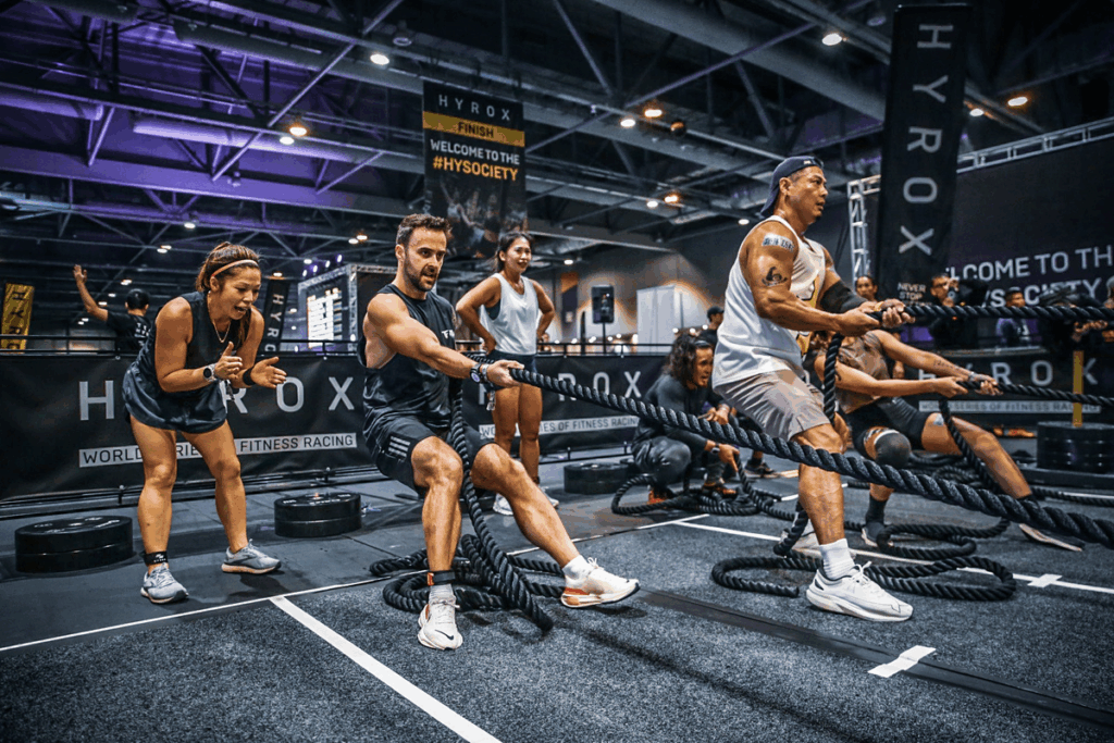 HYROX competitors pulling weighted ropes