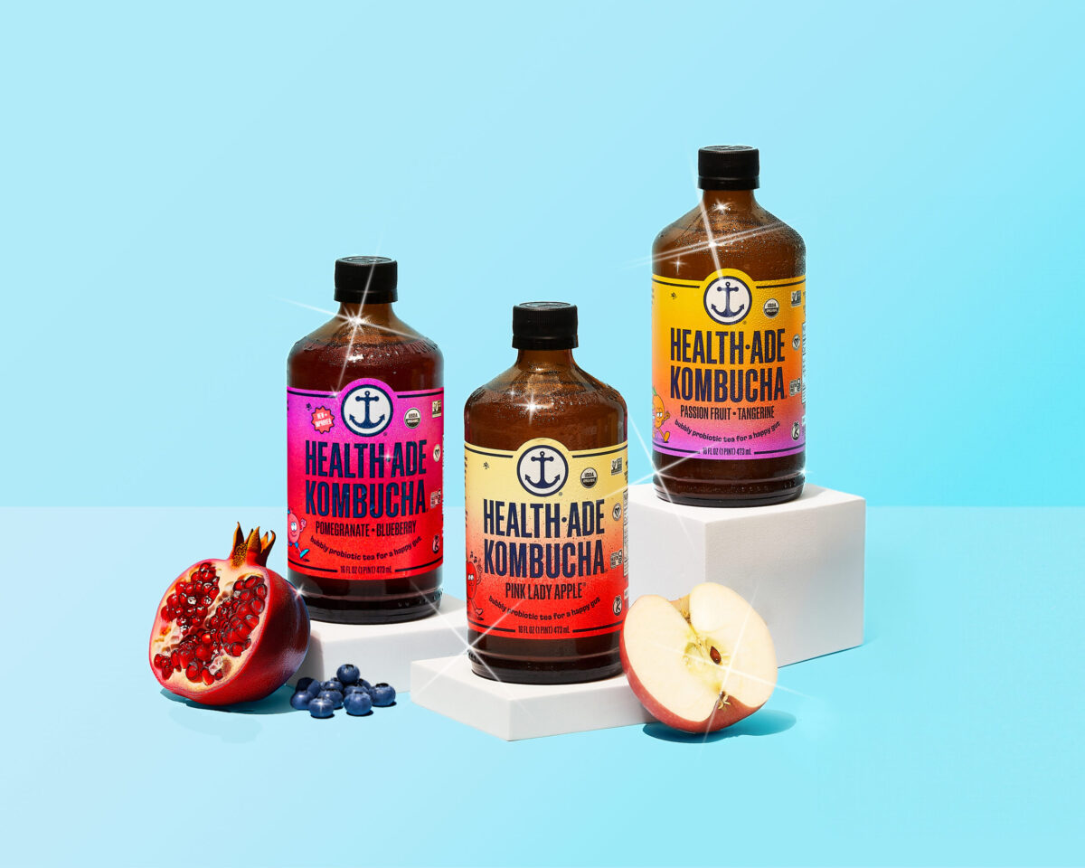 Health-Ade kombucha bottles on a blue background