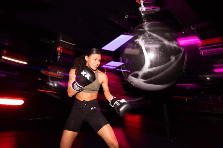 A woman practicing boxing moves on a punching bag