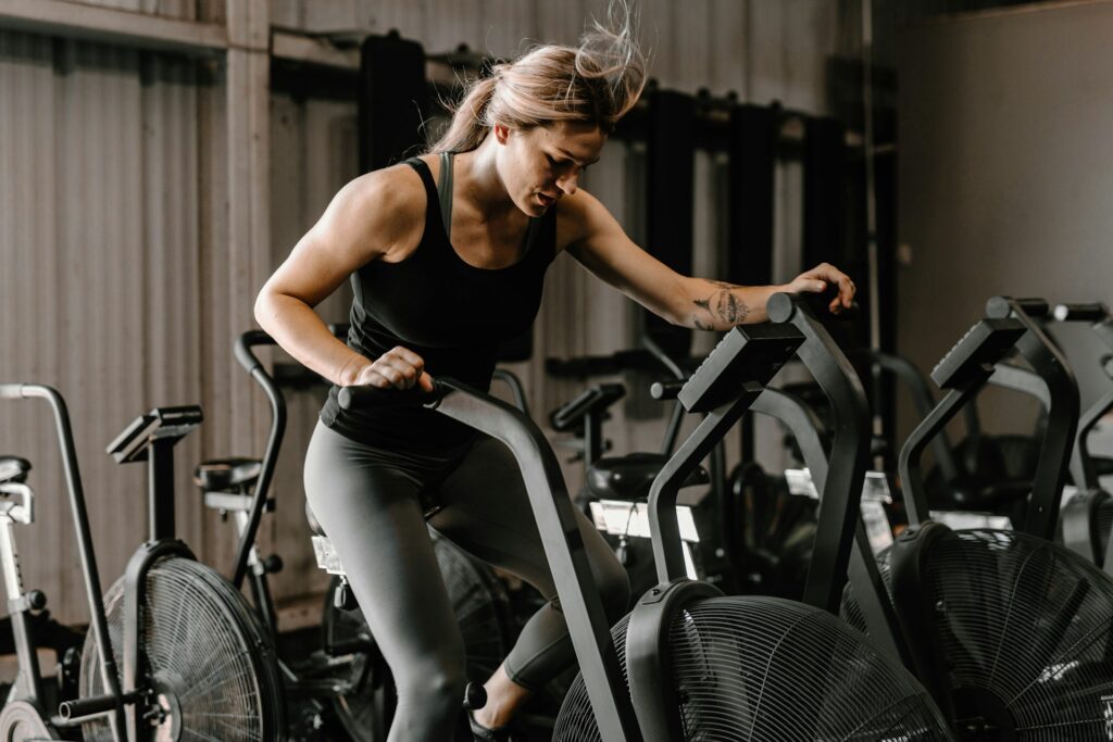 A woman exercising on a stationary bike