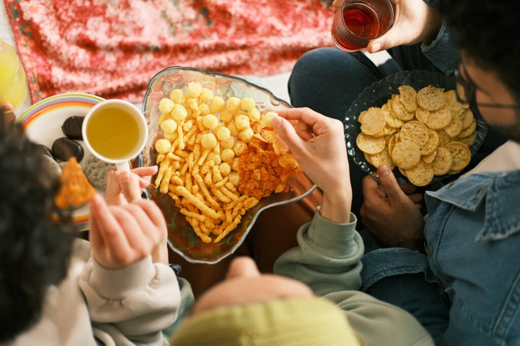 Friends eating snacks on the couch