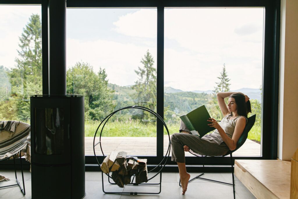 A woman sitting and reading in a cabin
