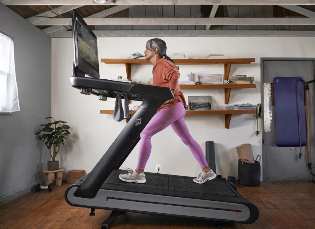 Woman walking on a treadmill at an incline