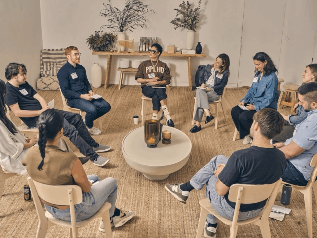 Group of people sitting on chairs in a circle