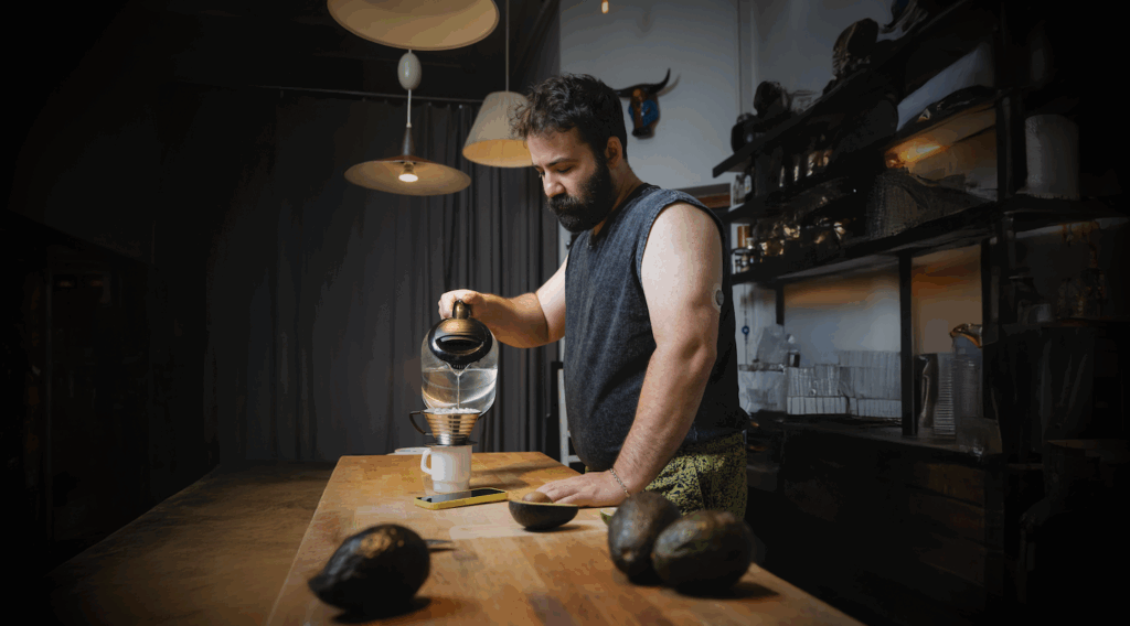 Man wearing a CGM while pouring a smoothie