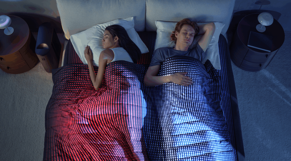 Man and woman in bed with a temperature-controlled blanket