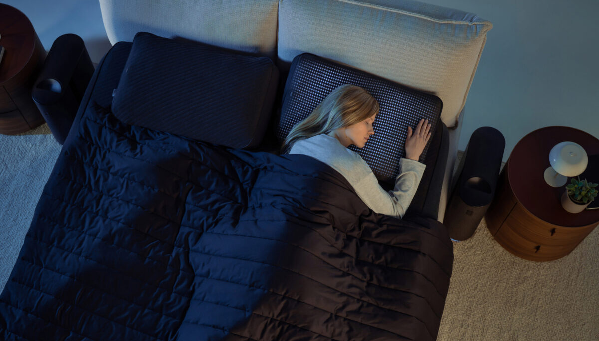 Woman sleeping with Eight Sleep pillow cover
