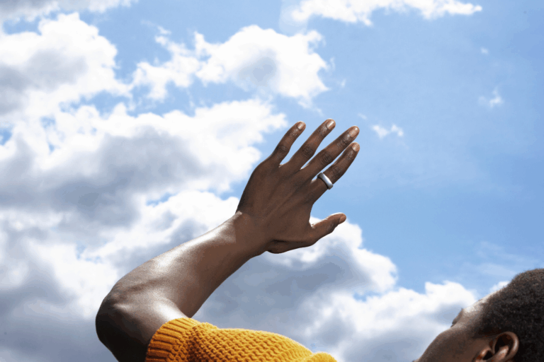 Oura ring worn outside with clouds in view