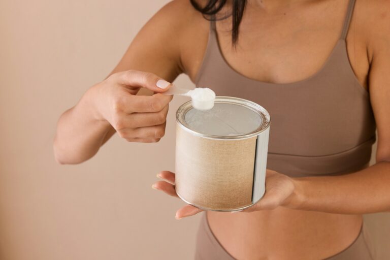 A woman scooping creatine powder