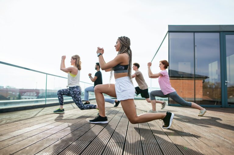 Group of people performing a single leg lunge