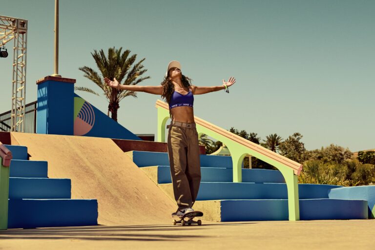 Rayssa Leal on skateboard with arms open