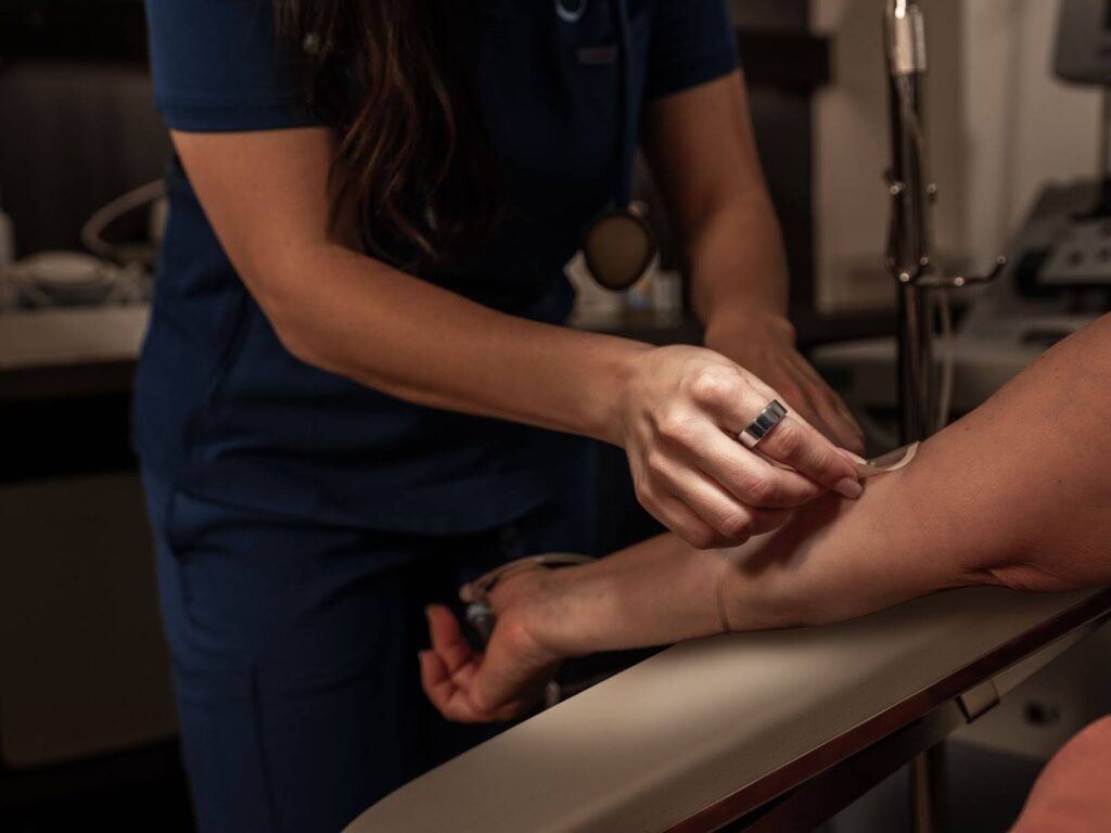 Nurse with Oura ring administering blood exam