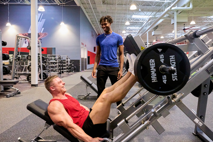 Man performing a heavy leg press at the gym