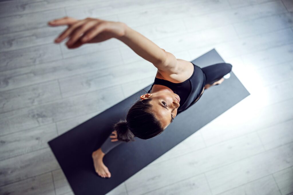 Woman doing yoga on mat