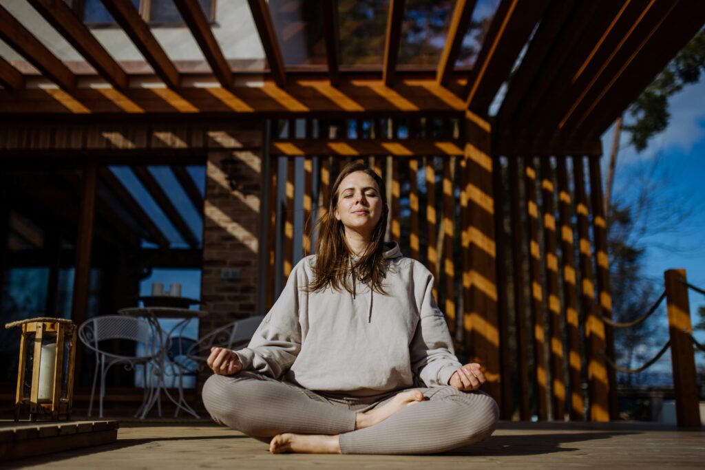 A woman meditating outdoors