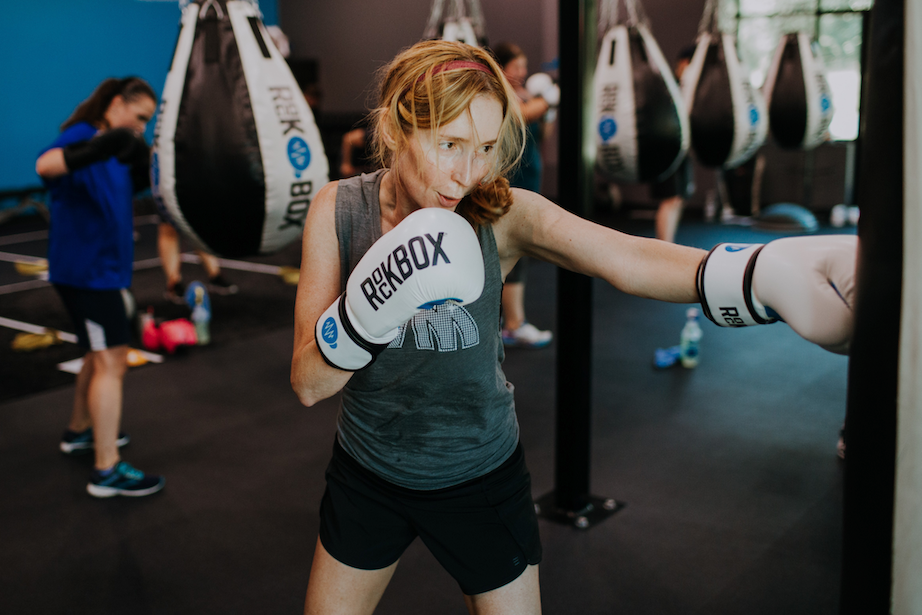 Woman punching a punching bag at RockBox Fitness