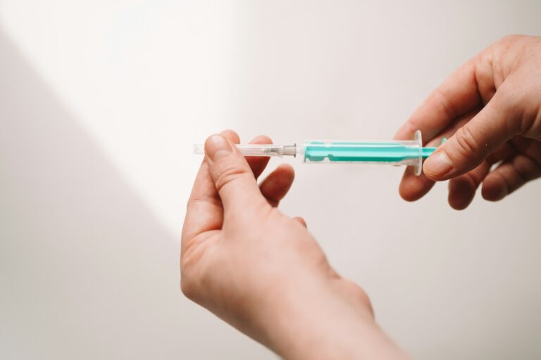 Person holding a syringe