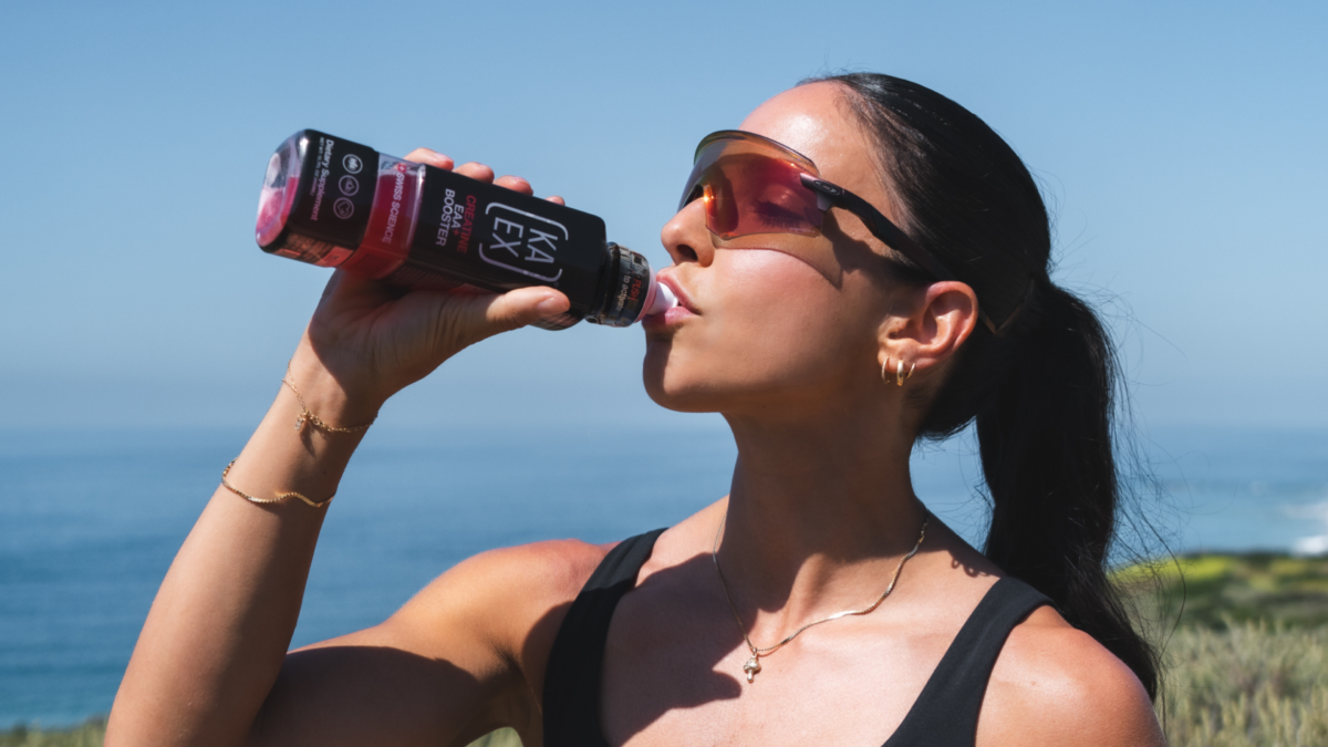 Woman drinking KA-EX Creatine EAA+ Booster