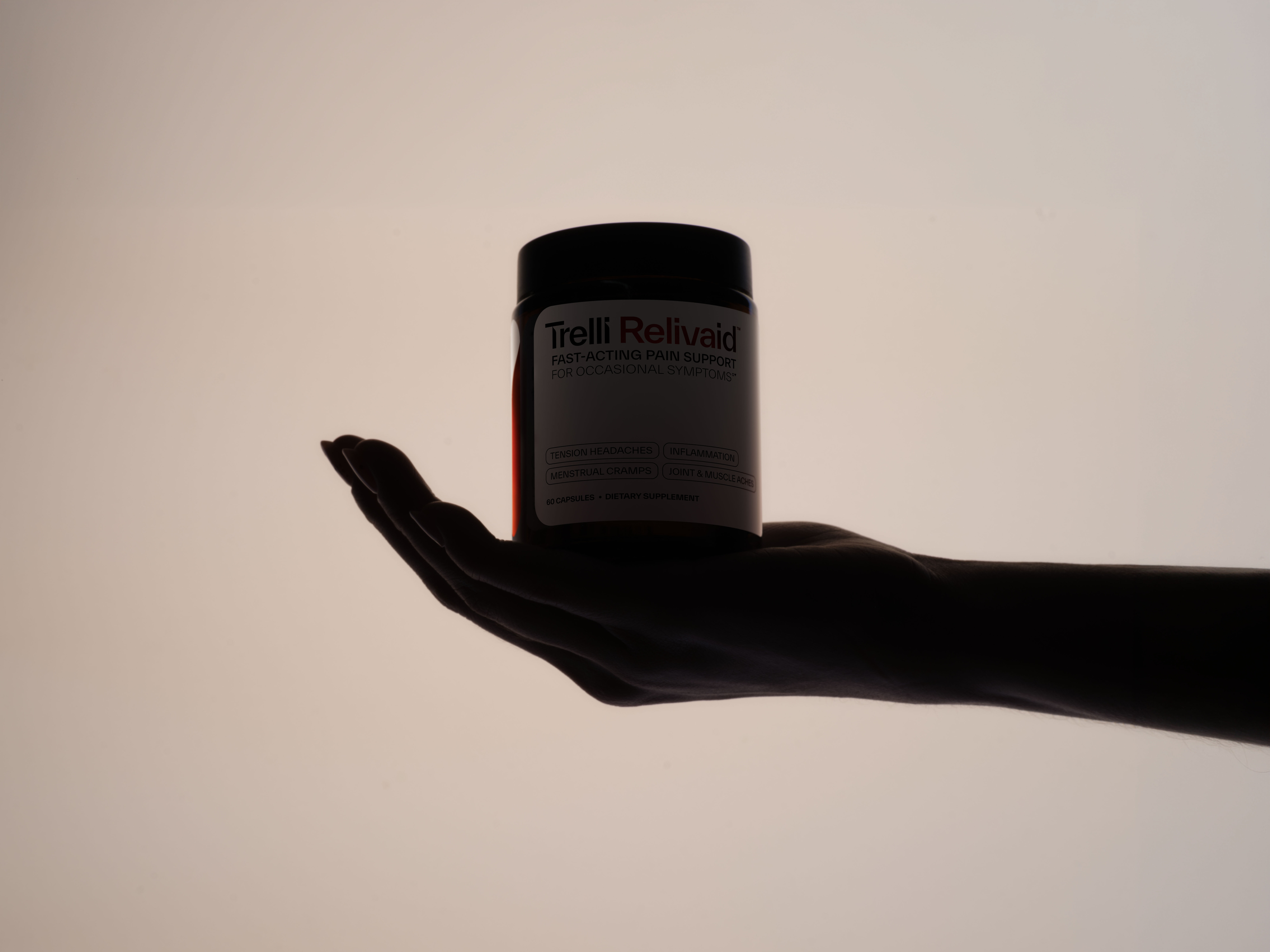 Hand holding Trelli's Relivaid supplement