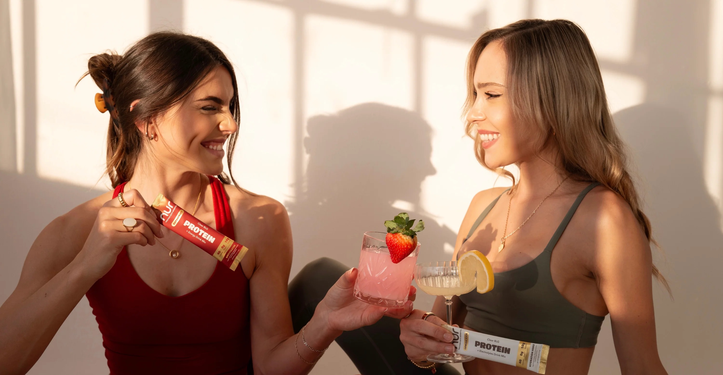 Two women with NUR hydration packets