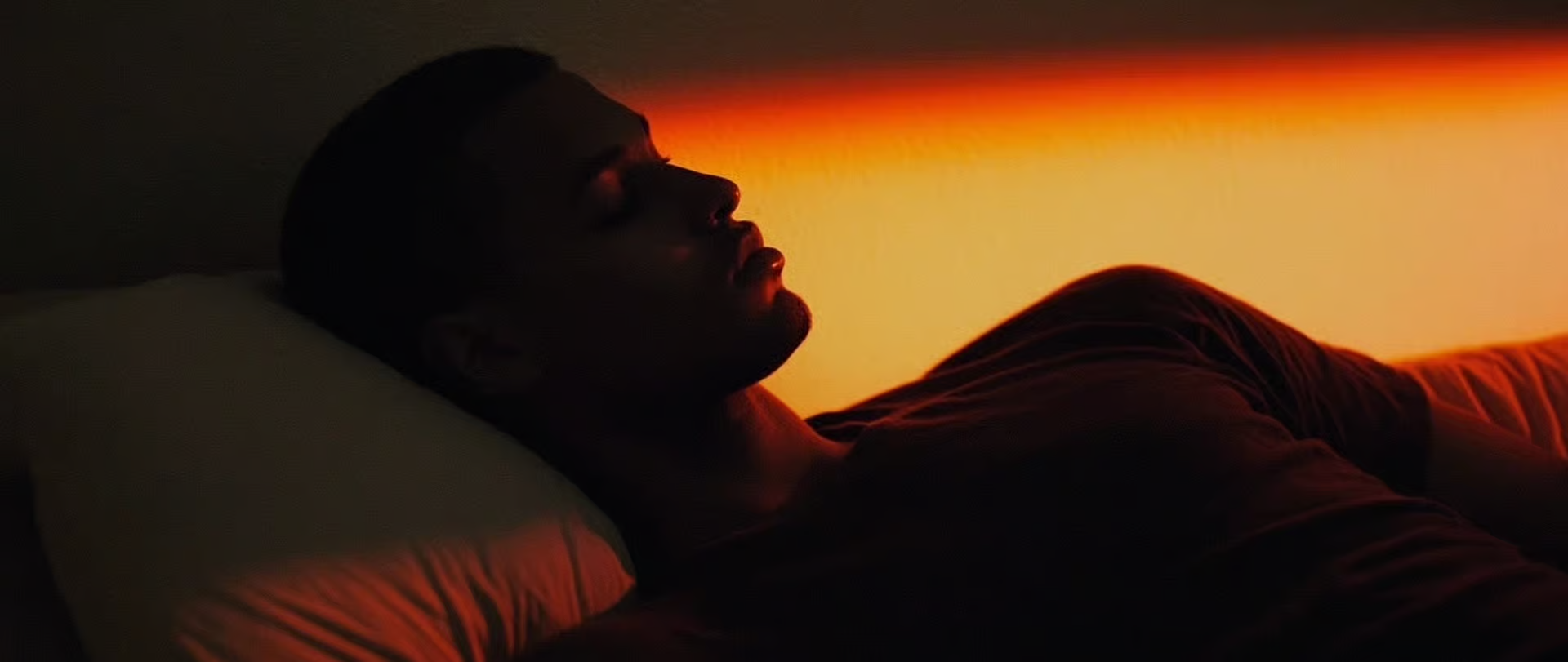 Dark-lit image of a man sleeping