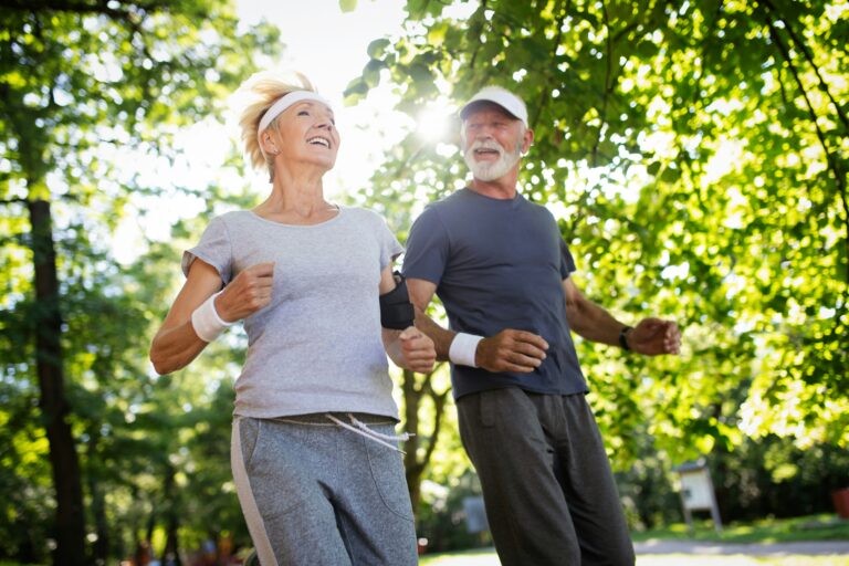 Elder couple running in a park