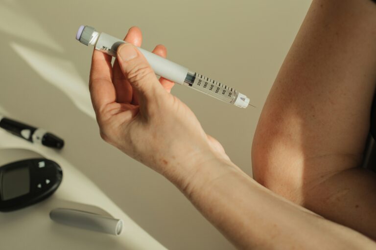 A person holding a GLP-1 injection