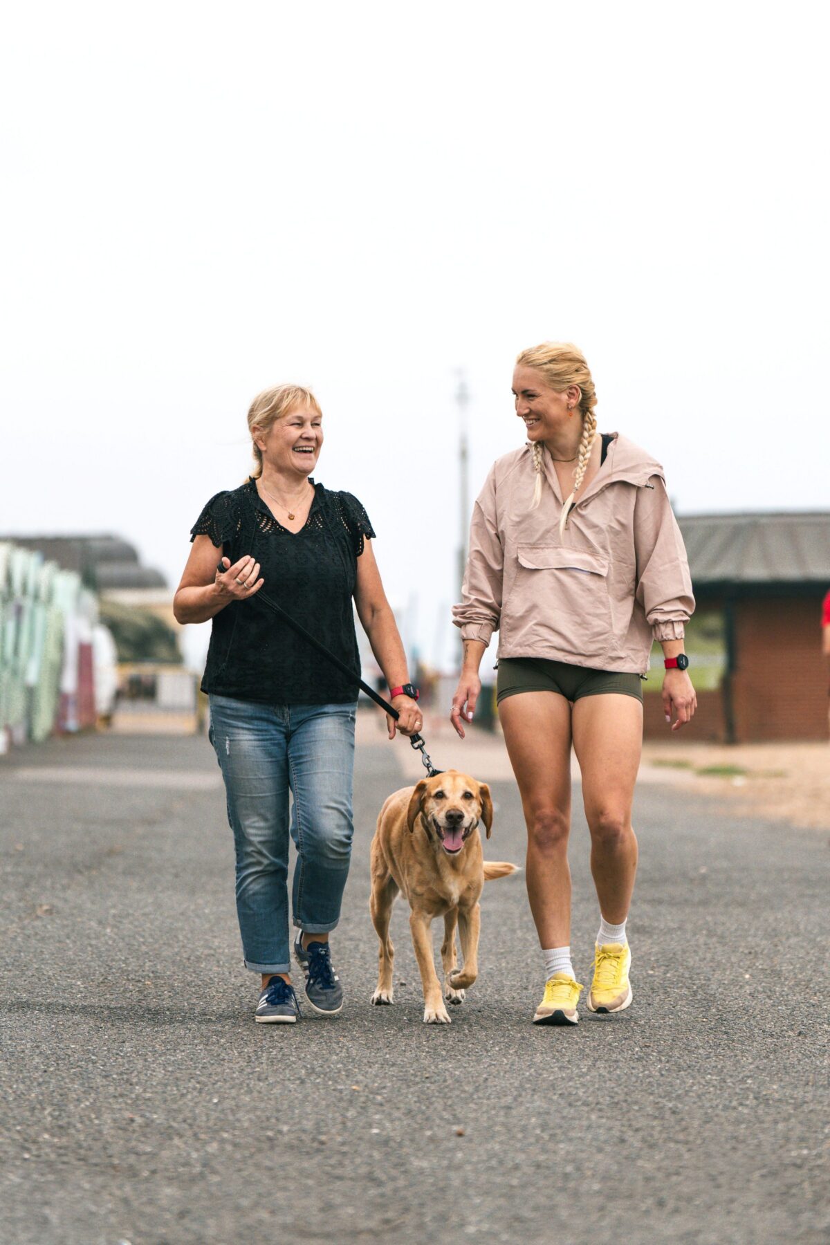 Two women walking a dog