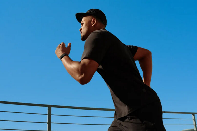 Man running with Fitbit Air on