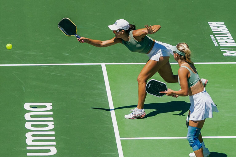 Two women playing pickleball