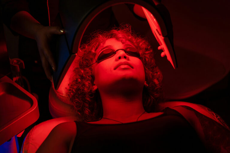 Woman receiving red light treatment
