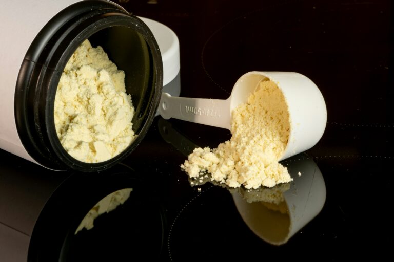Whey protein scoop and canister