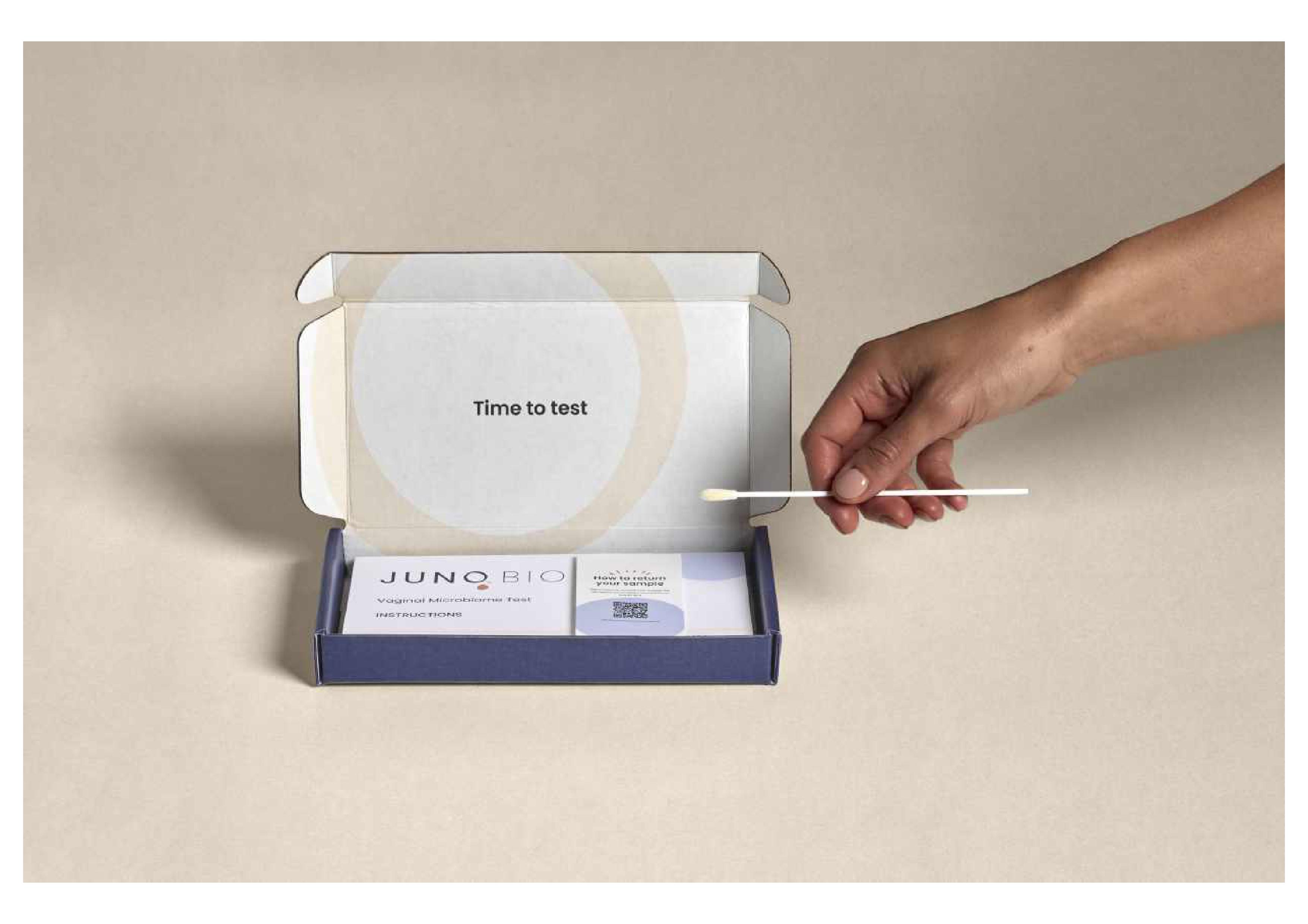 Juno Bio vaginal microbiome test kit with hand holding swab