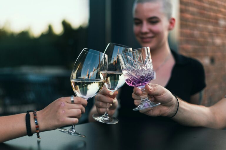 A group of people drinking with wine glasses
